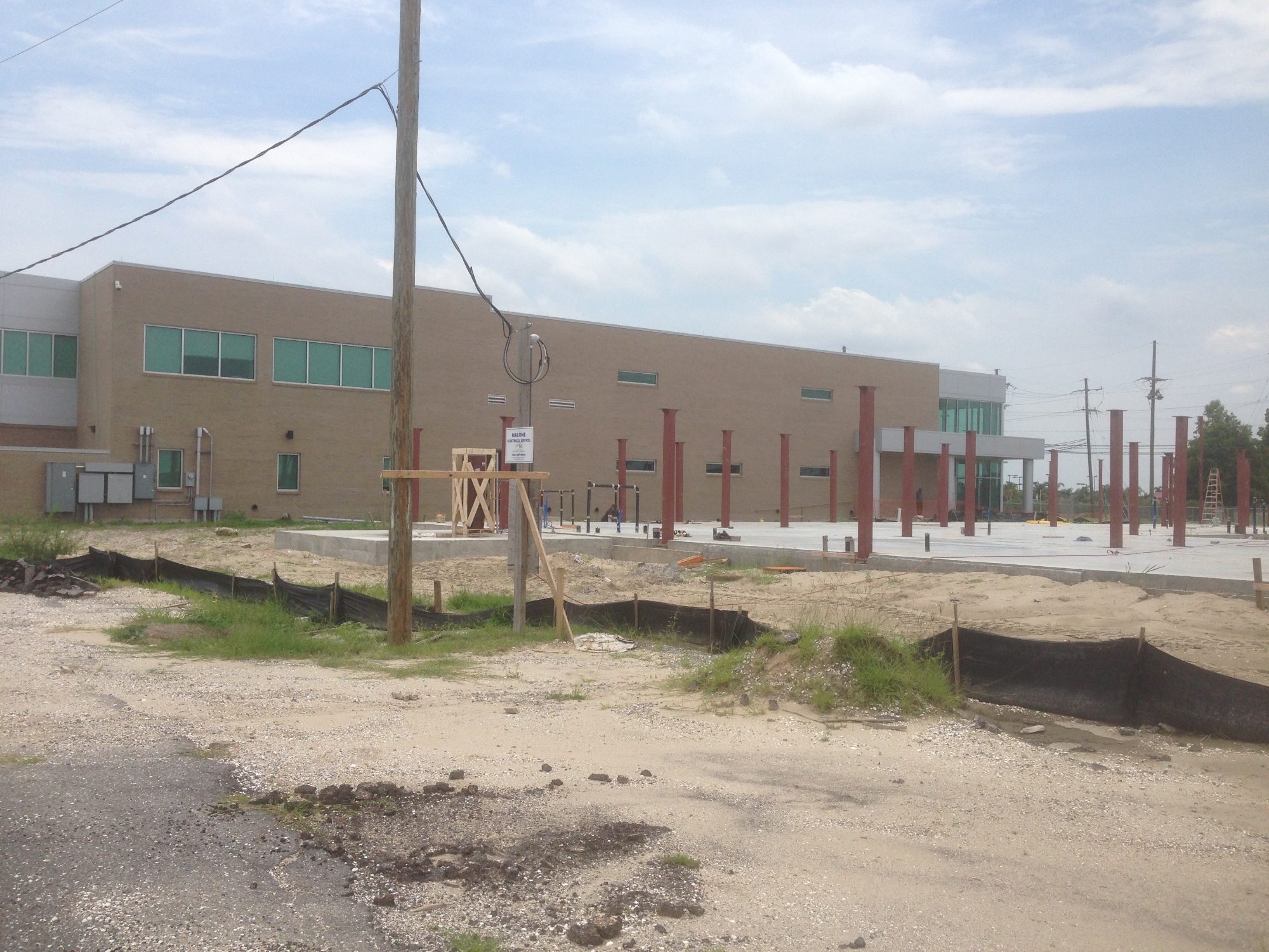 Steel columns and red support pillars with existing building
